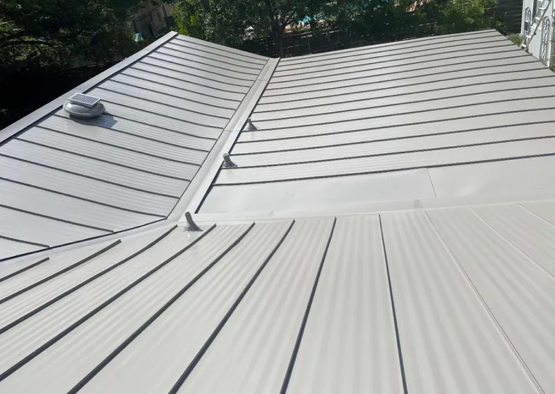 Solar attic fan installed on a metal roof for Roof Ventilation in Buffalo